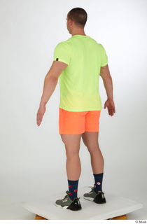 Joel a-pose dressed green sneakers orange shorts sports standing whole…